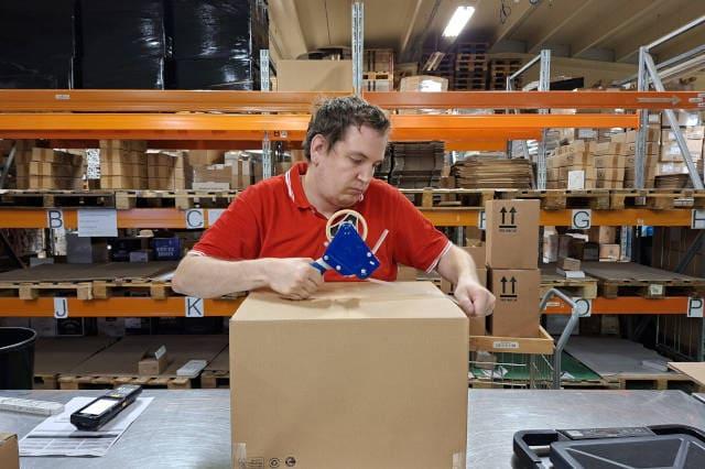 A team member packing a package