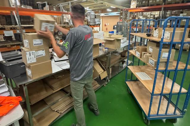 A logistics specialist packs e-commerce orders.