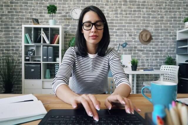 A secretary typing on a keyboard